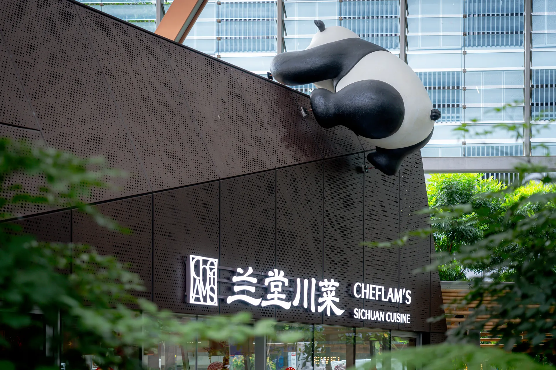 CHEFLAM'S facade with its panda sculpture and illuminated restaurant sign
